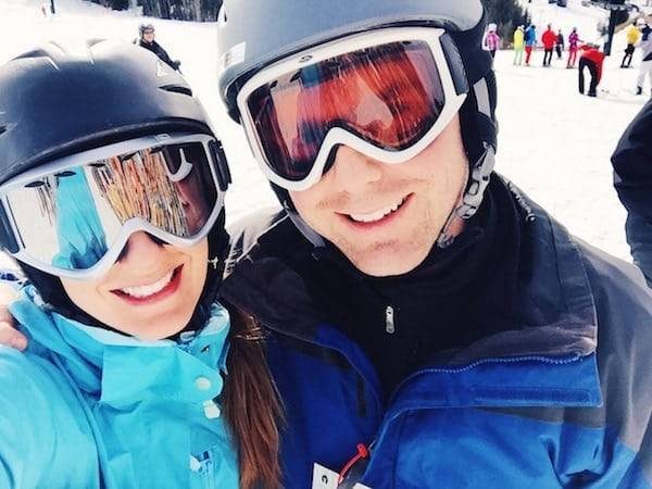 Woman and man wearing ski gear.