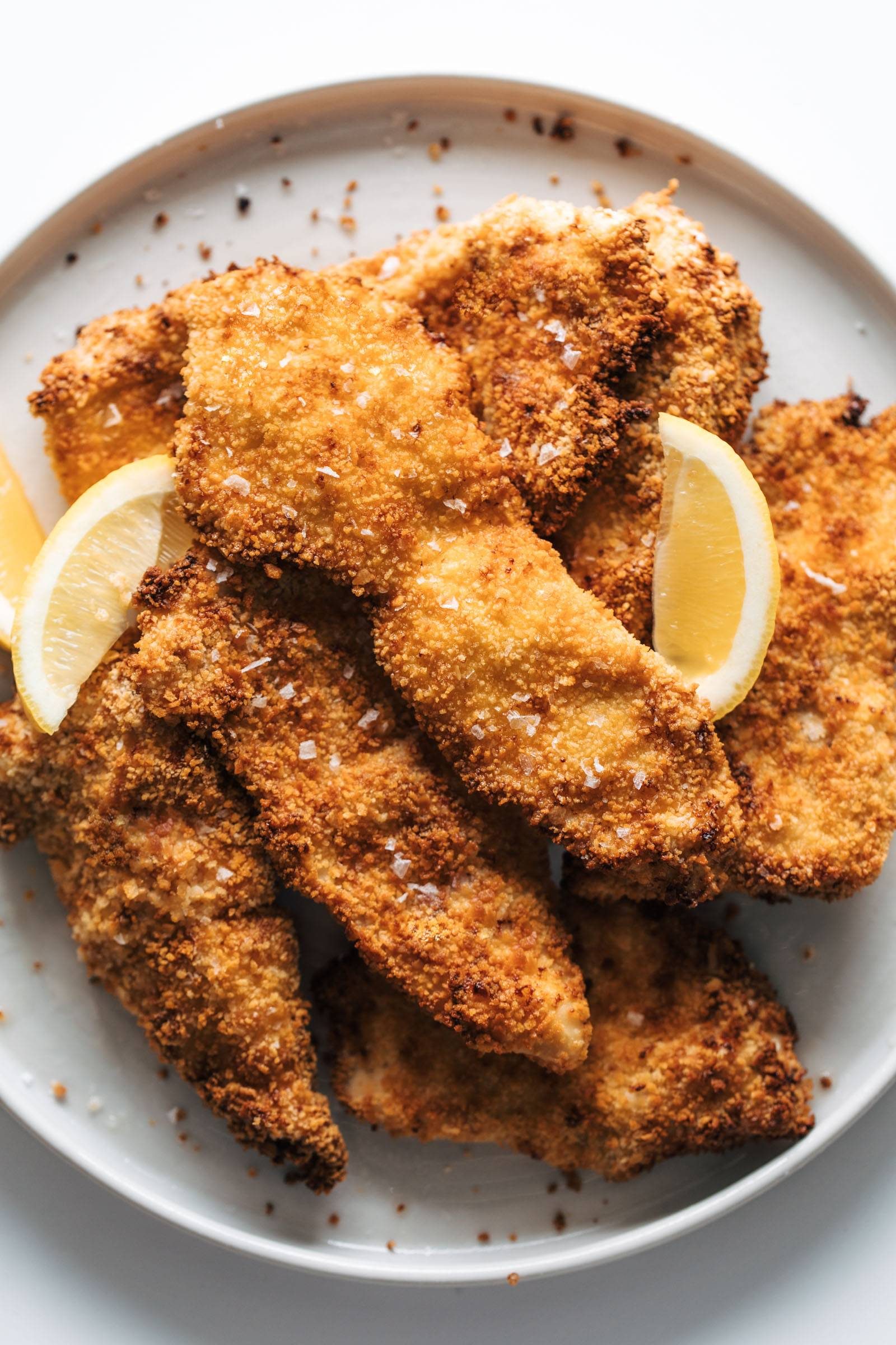 Crispy air-fried chicken cutlets on a plate.