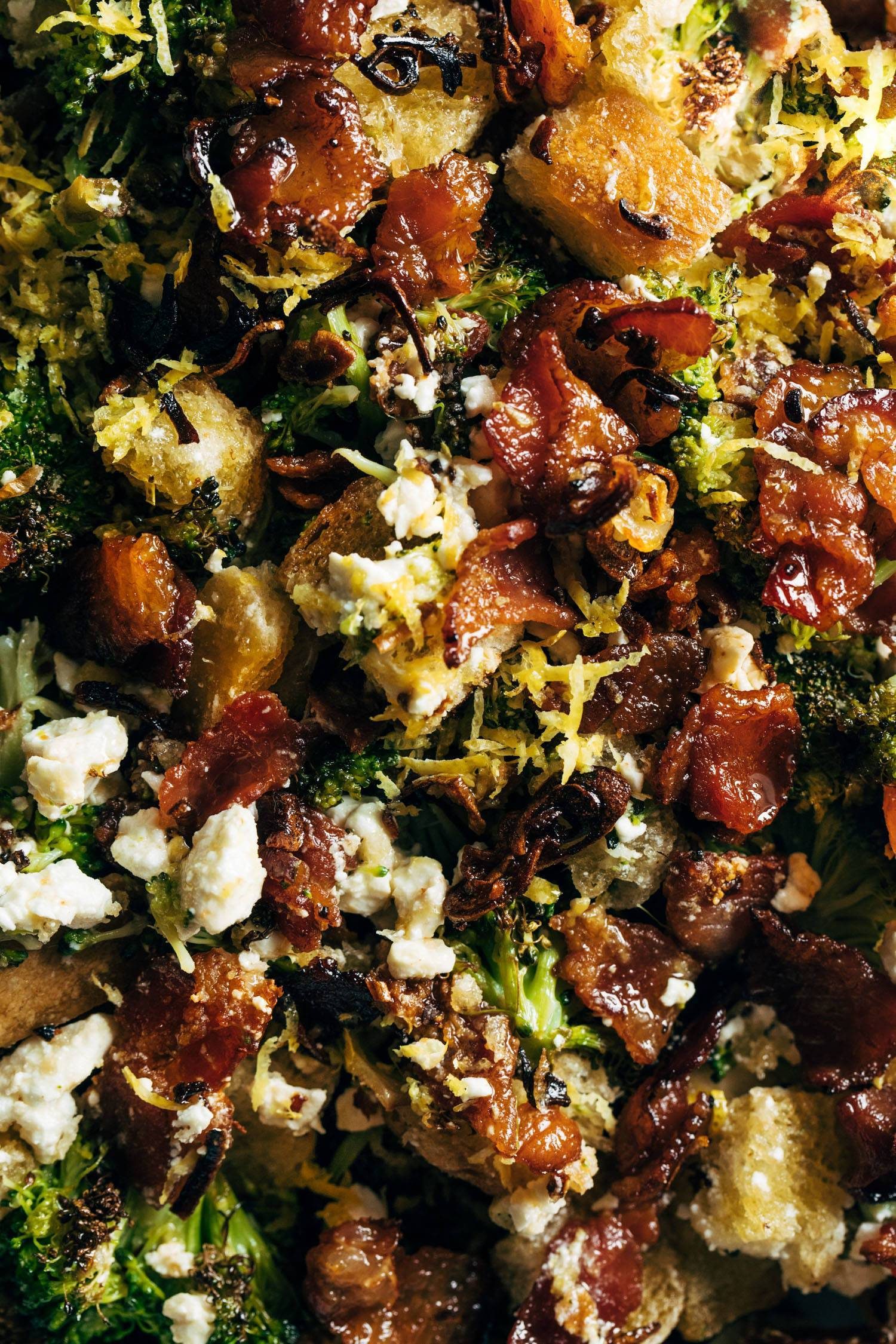 A broccoli salad with with bacon and croutons in it.