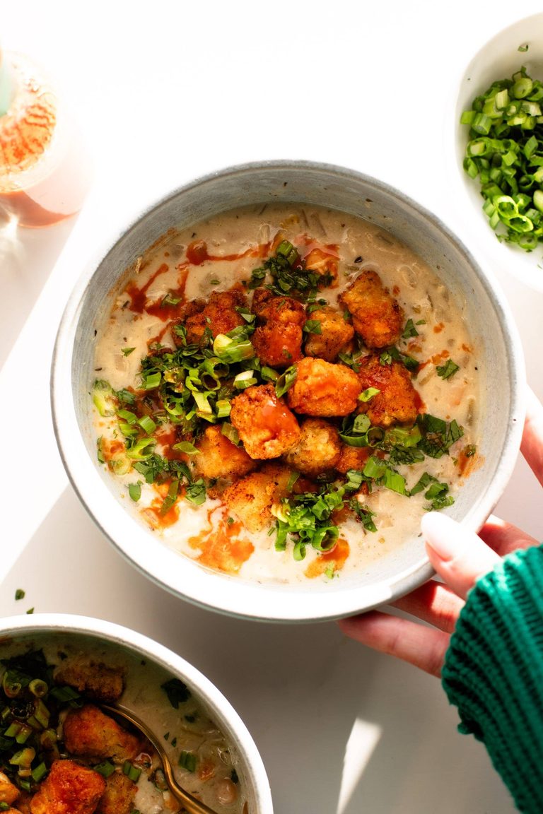 White chicken soup with tots on top.