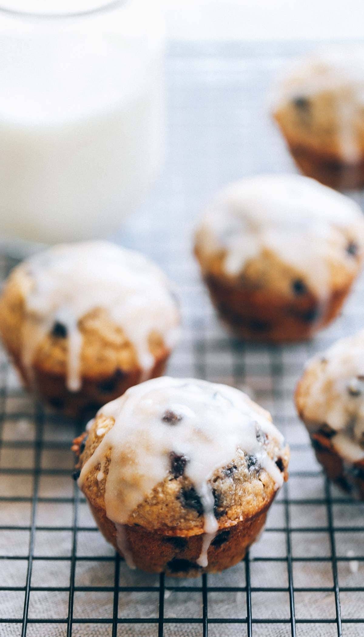 Whole Wheat Blueberry Muffins on a drying rack with glaze.