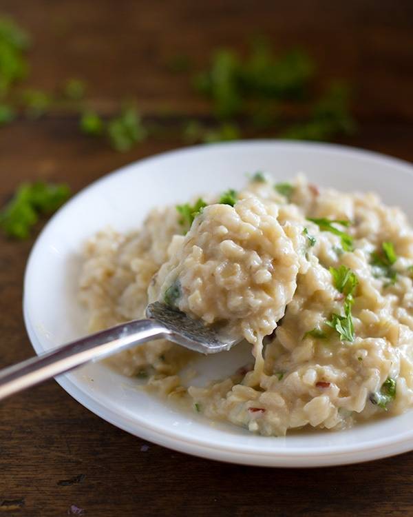 This creamy cauliflower garlic rice is simple, healthy, and so surprisingly good! With garlic, butter, brown rice, and cauliflower. | pinchofyum.com