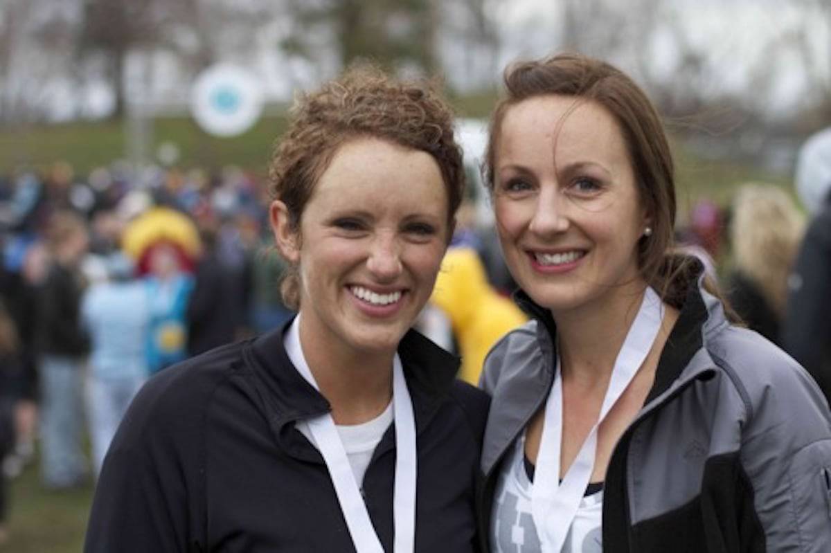 Two women with ribbons around their necks.