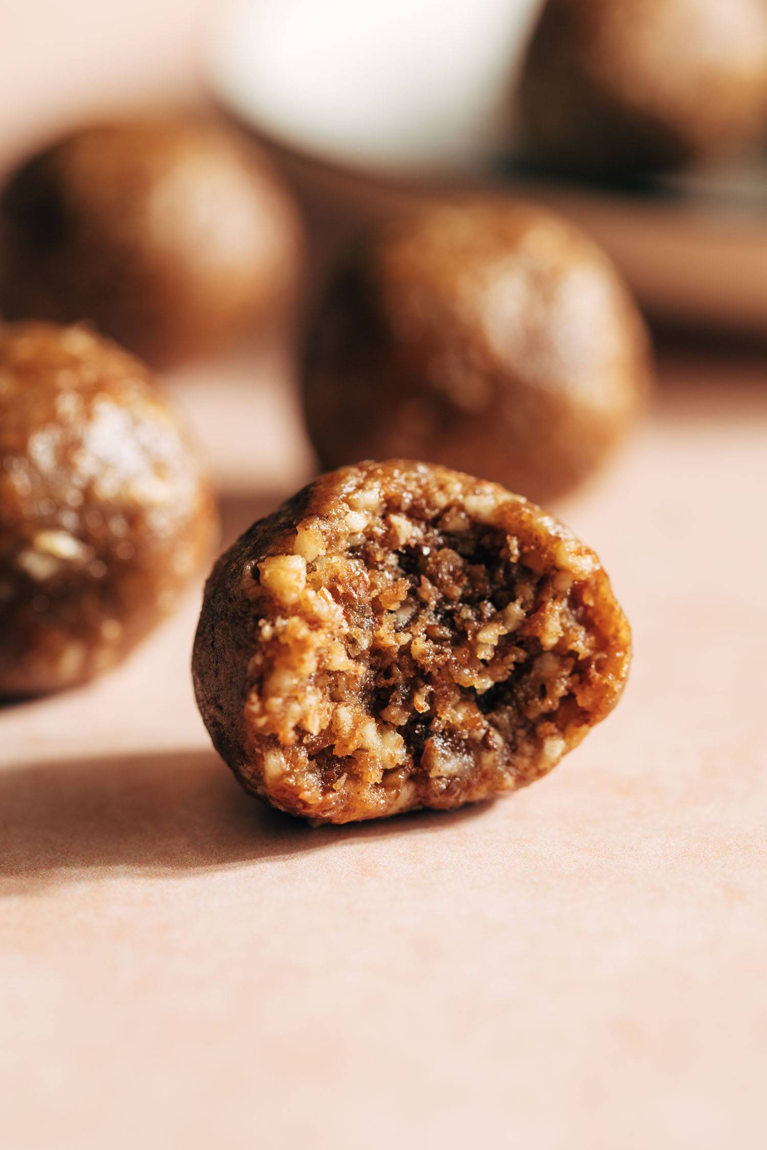 Pecan pie energy bite with a bite taken out of it